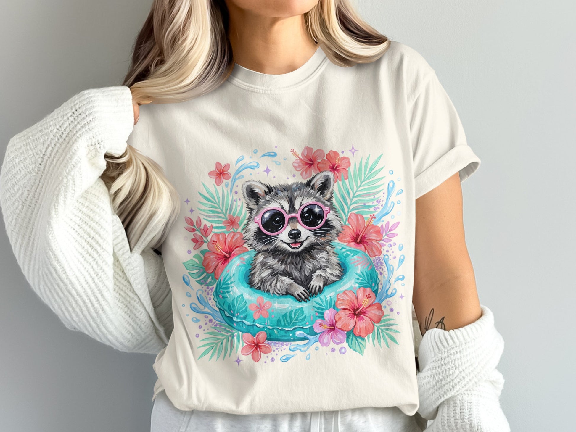 Raccoon wearing pink sunglasses floats in inner tube with tropical flowers.