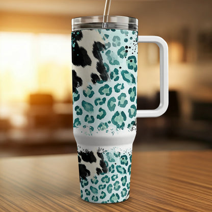 Tumbler with teal and black cowhide leopard print and white handle.
