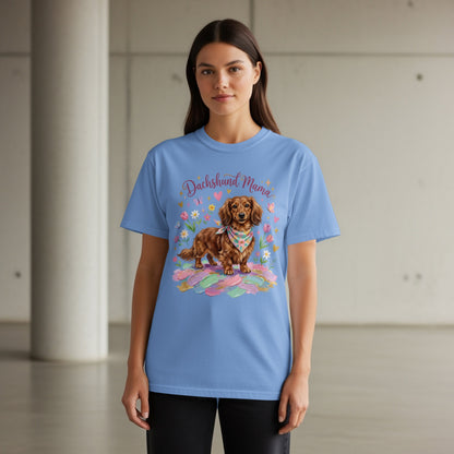 Blue t-shirt with a brown dachshund wearing a bandana, surrounded by feathers and butterflies.