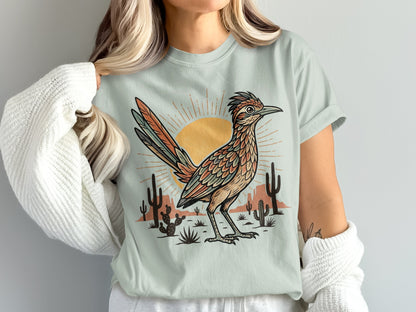 T-shirt with desert scene, sun, saguaro cacti, and roadrunner illustration.