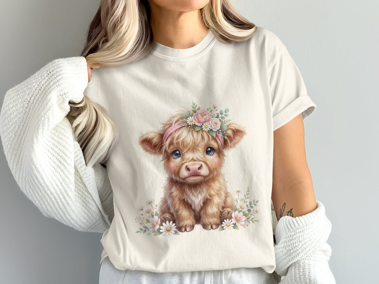 Cream t-shirt with a fluffy baby cow wearing a floral headband.