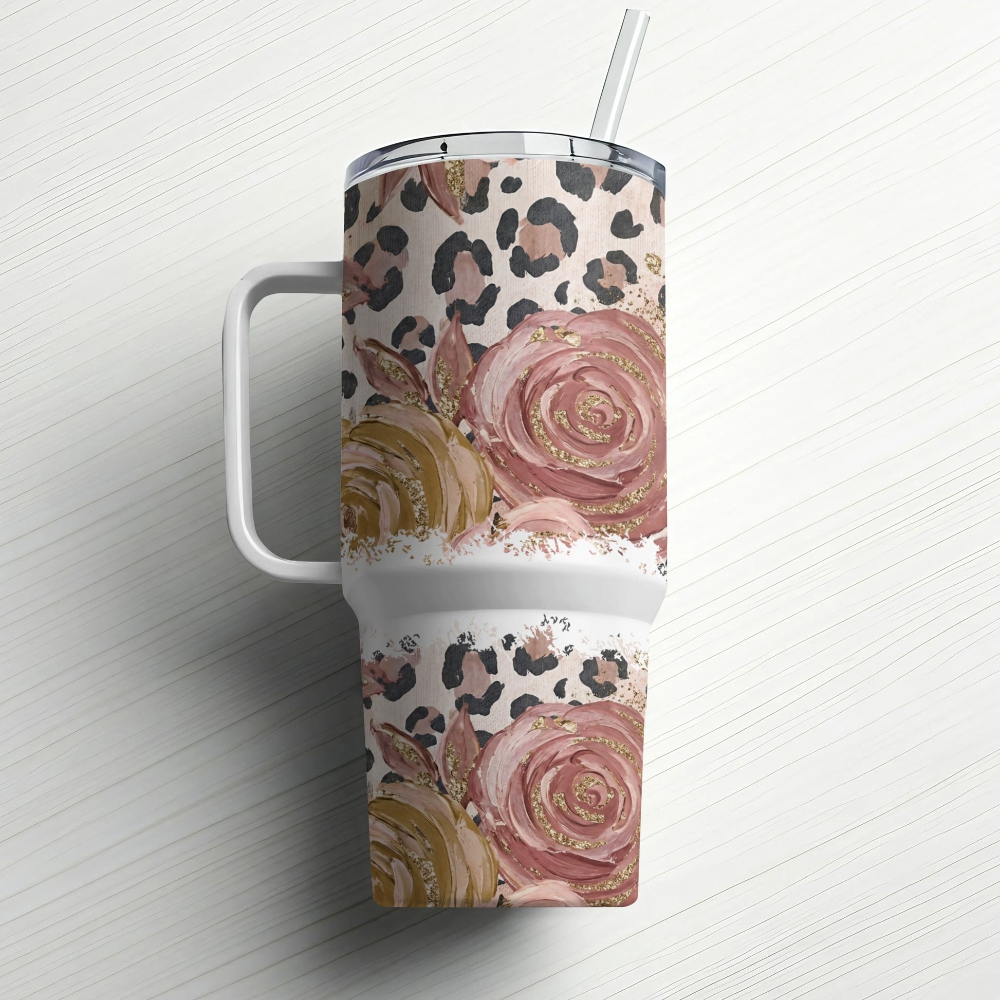 Floral and leopard print tumbler with handle and straw.