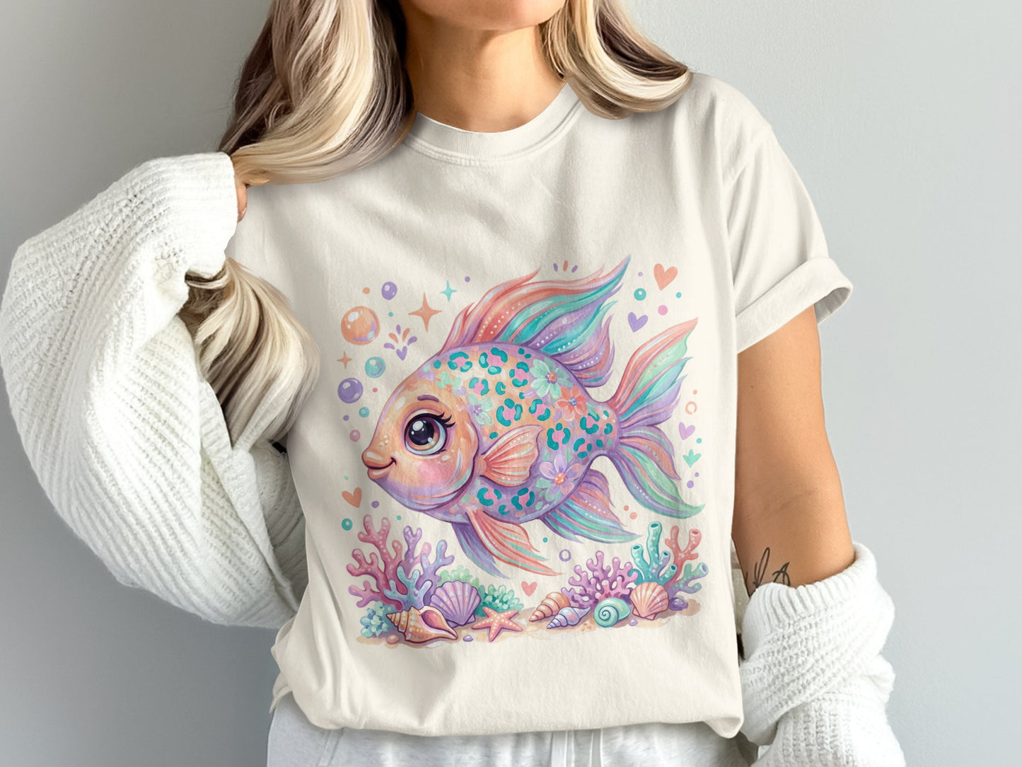 Cute cartoon fish with flowers, shells, and coral on a white t-shirt.