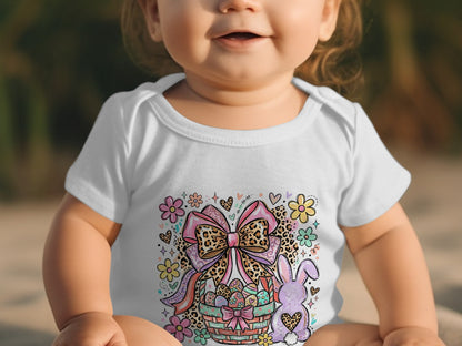 Baby in white onesie with Easter basket, bunny, and bow graphic.