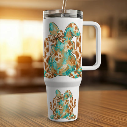 White tumbler with a blue and brown abstract bunny and cactus pattern.