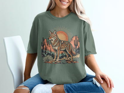 Desert scene with coyote illustration on a green t-shirt.