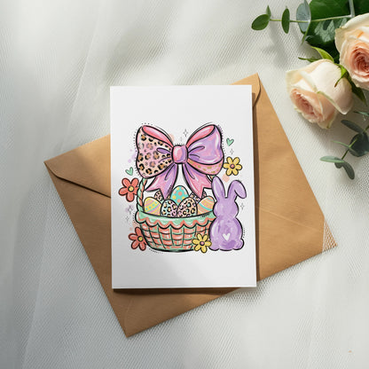 Easter card with decorated eggs, bow, bunny, and flowers on a basket.
