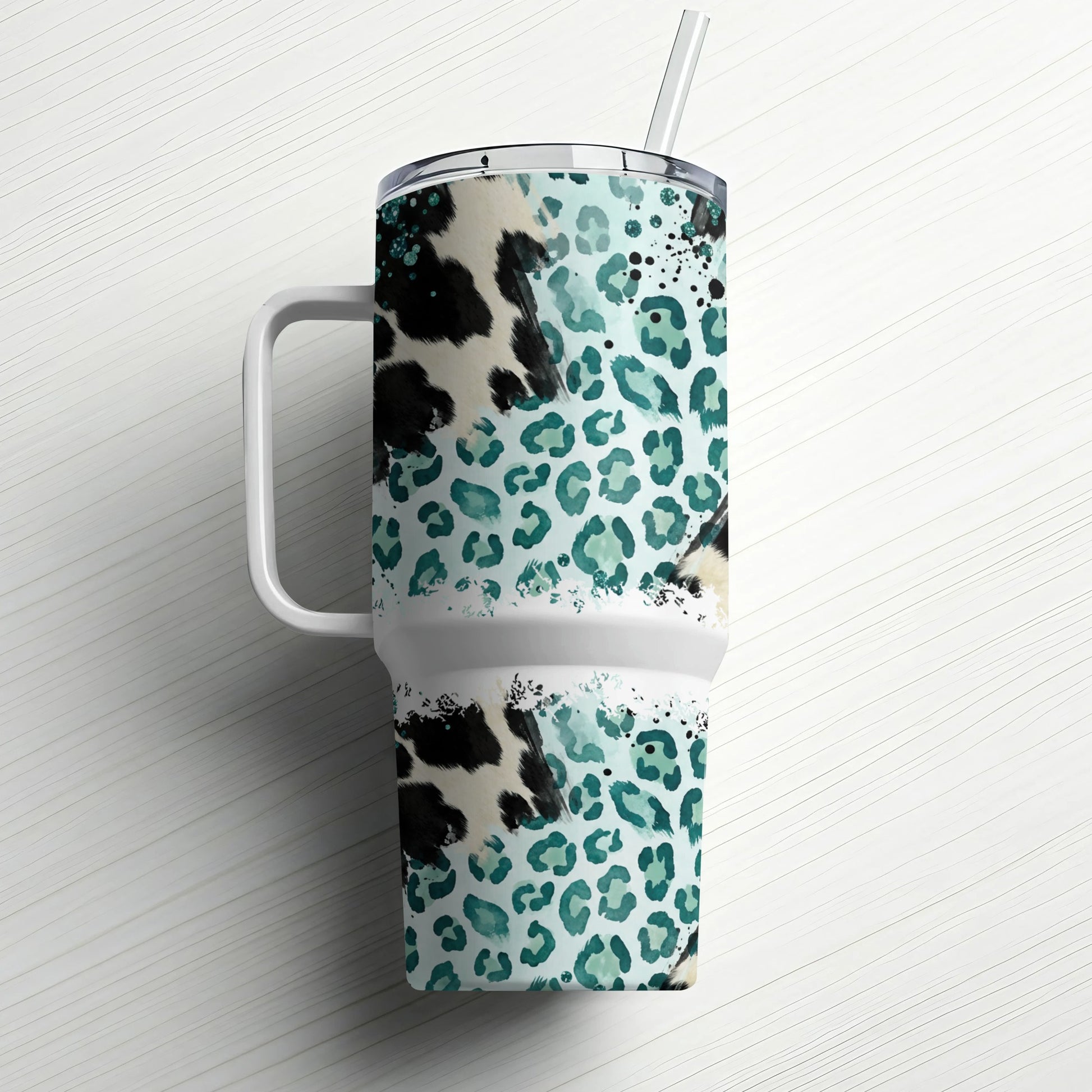 Large travel tumbler with teal leopard print and handle, with straw.