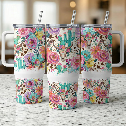 Three tumblers with floral and cowhide patterns and bull skulls.