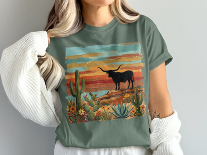 Green t-shirt with a desert landscape and longhorn bull illustration.
