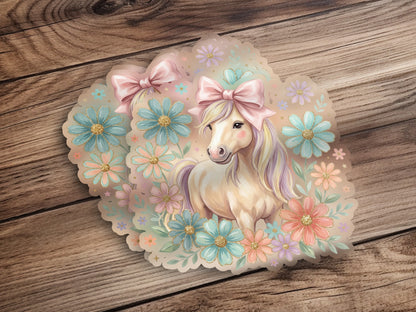 Illustration of a unicorn surrounded by pastel flowers and bows.