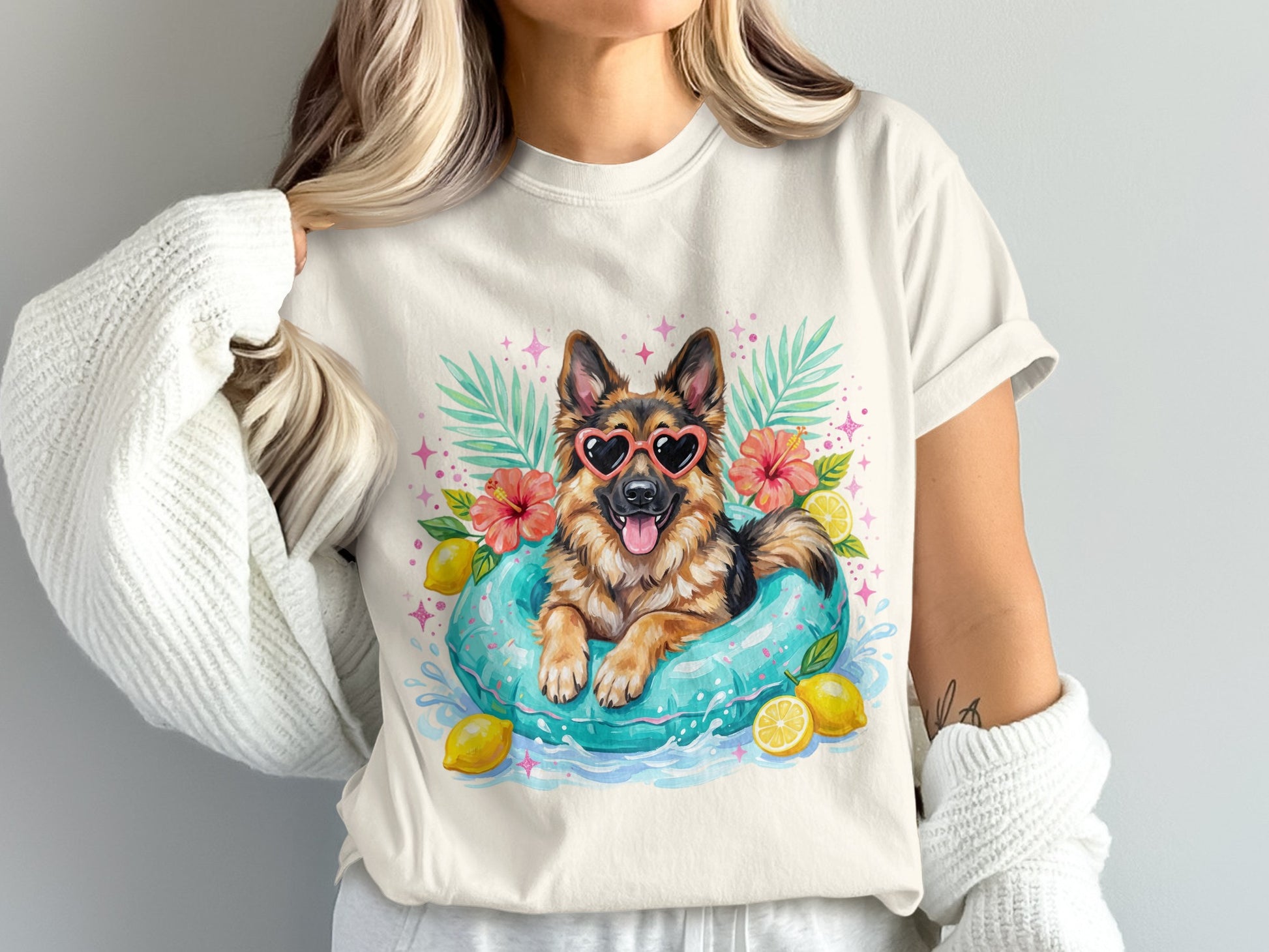 German Shepherd in inner tube with heart sunglasses and lemons.