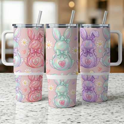 Three pastel Easter bunny tumblers with bows and flowers.
