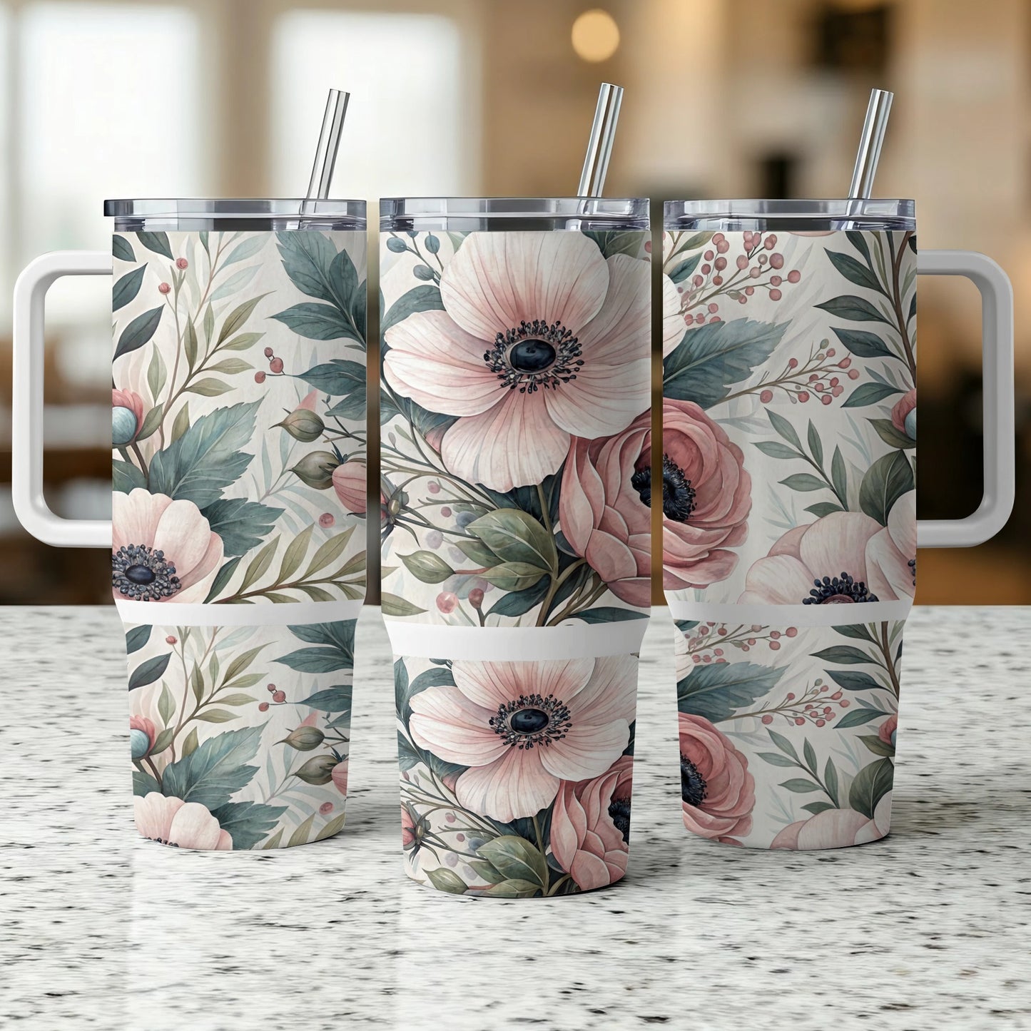 Three tumblers with floral designs and reusable straws.
