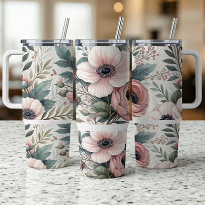 Three tumblers with floral designs and reusable straws.