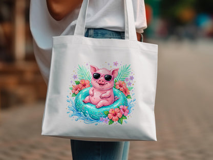 White tote bag with a cartoon pig in sunglasses on an inner tube.