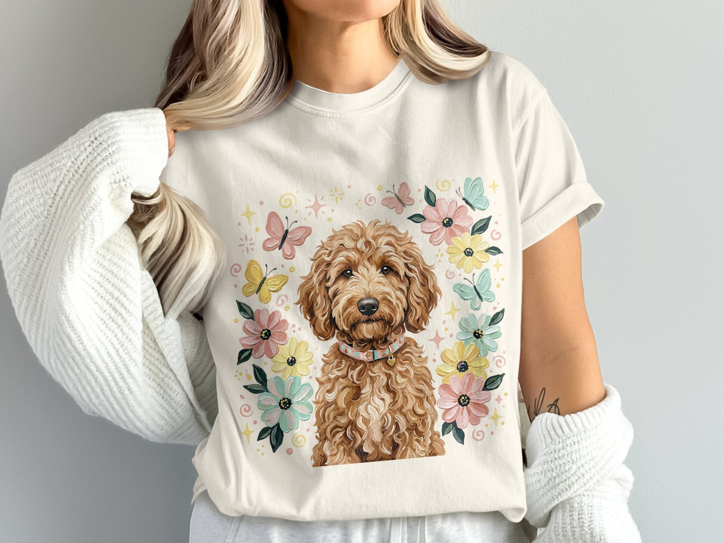 Cream t-shirt with a dog and floral butterfly graphic.