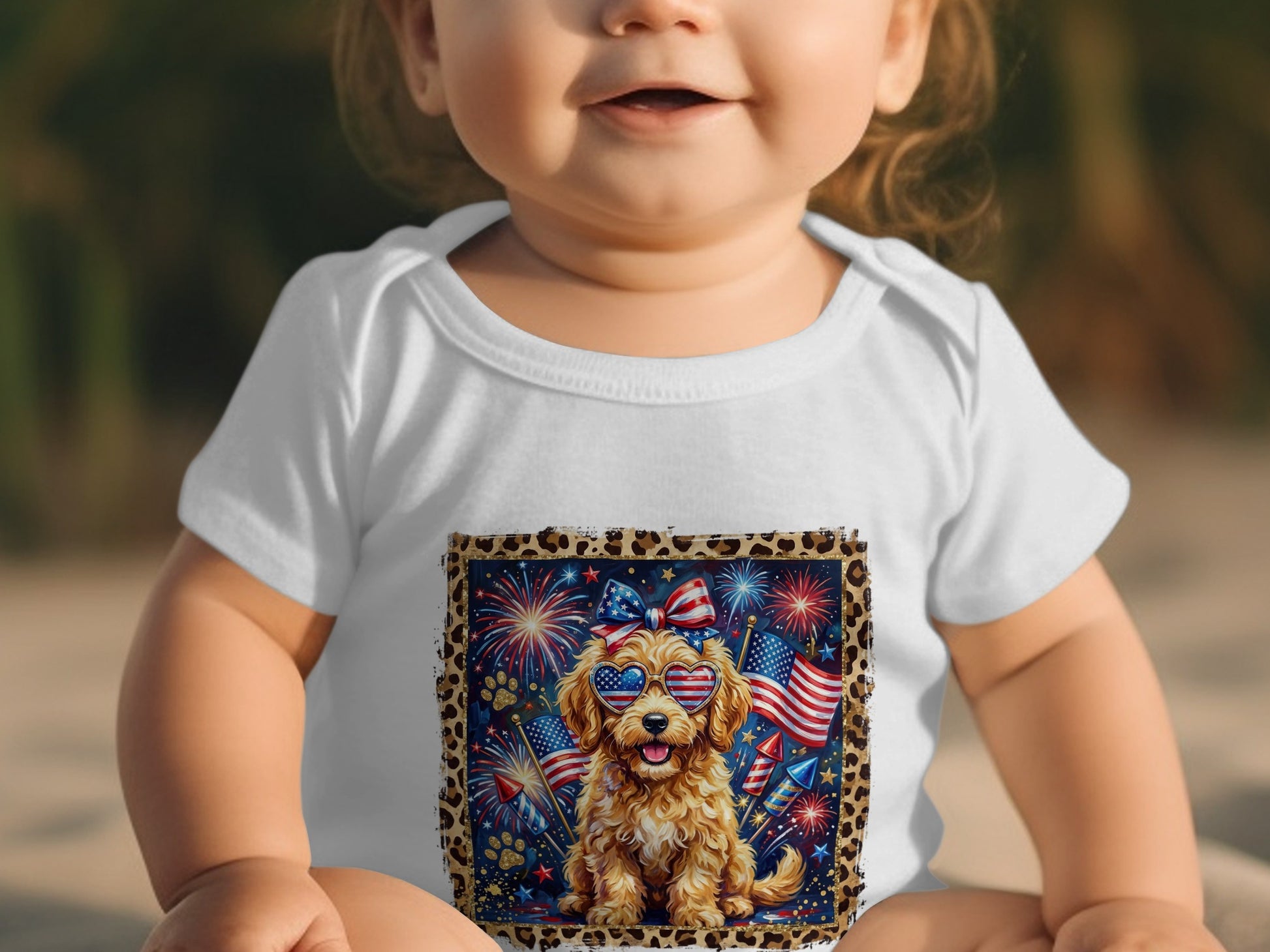 Baby wearing white bodysuit with patriotic dog graphic and fireworks.