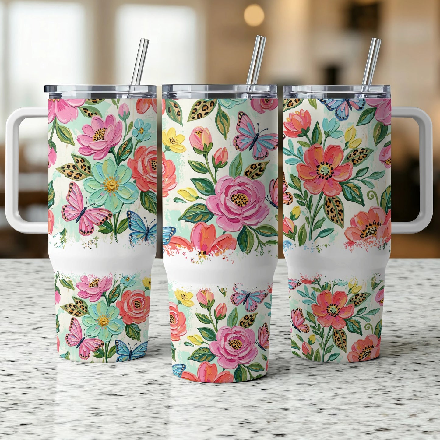 Three tumblers with floral and butterfly designs, each with a white band.