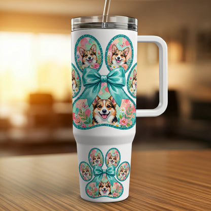White tumbler with Corgi paw prints and bows, accented with flowers and glitter.