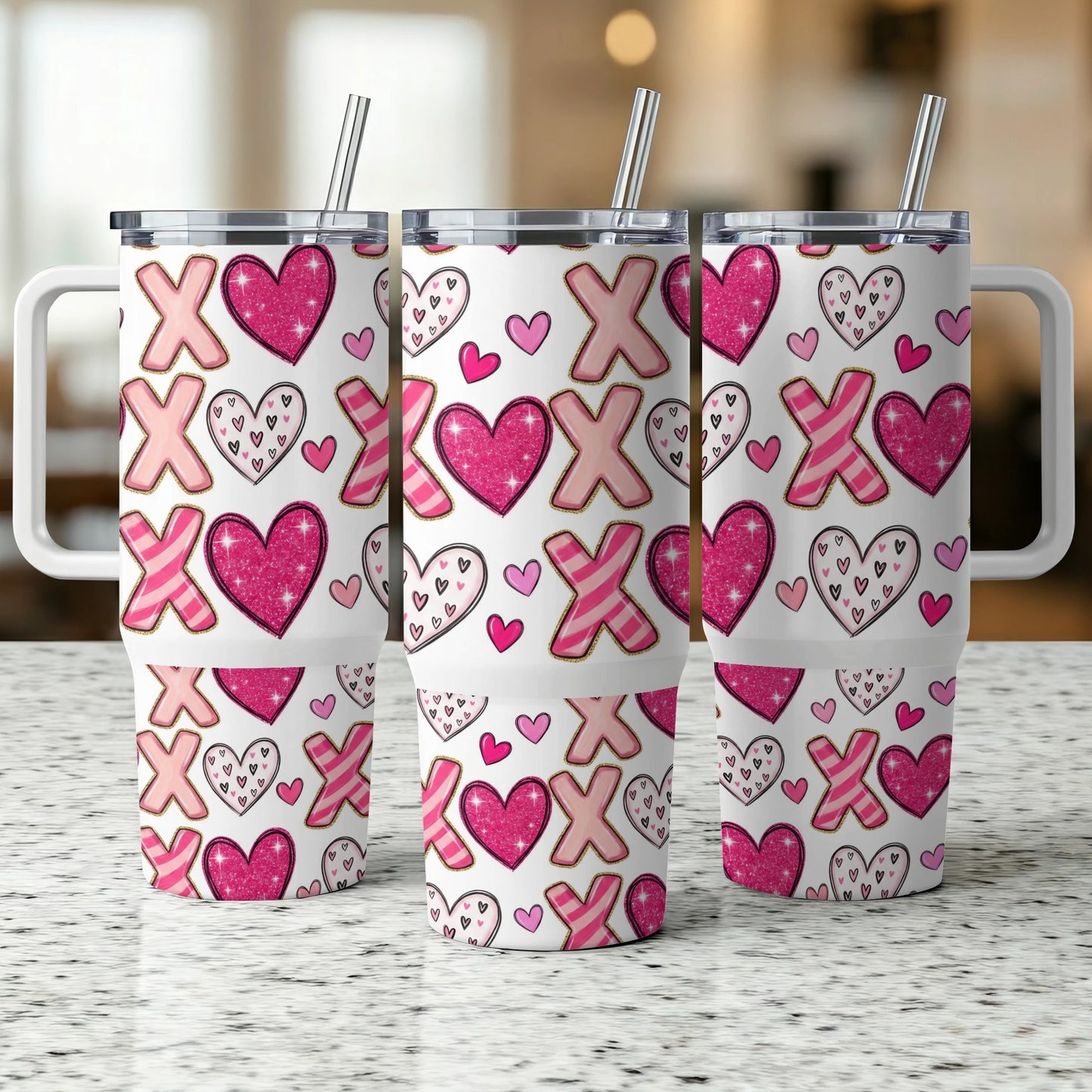 Three pink and white patterned tumblers with X and O designs.