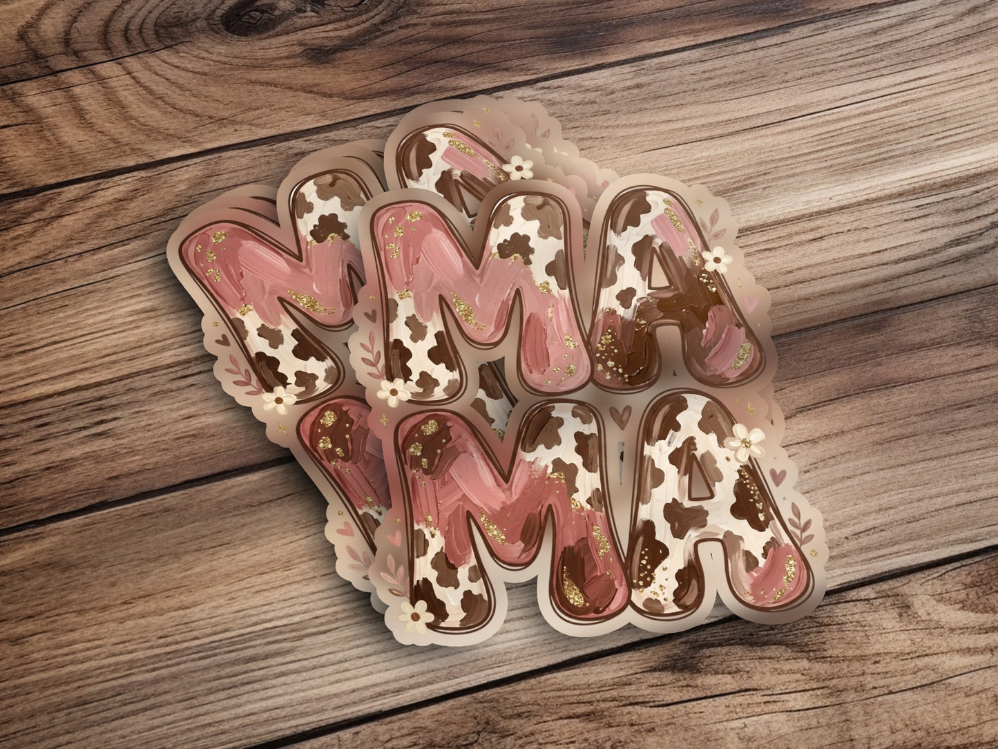 Brown and pink "Mama" lettering with cow print accents on a wooden background.