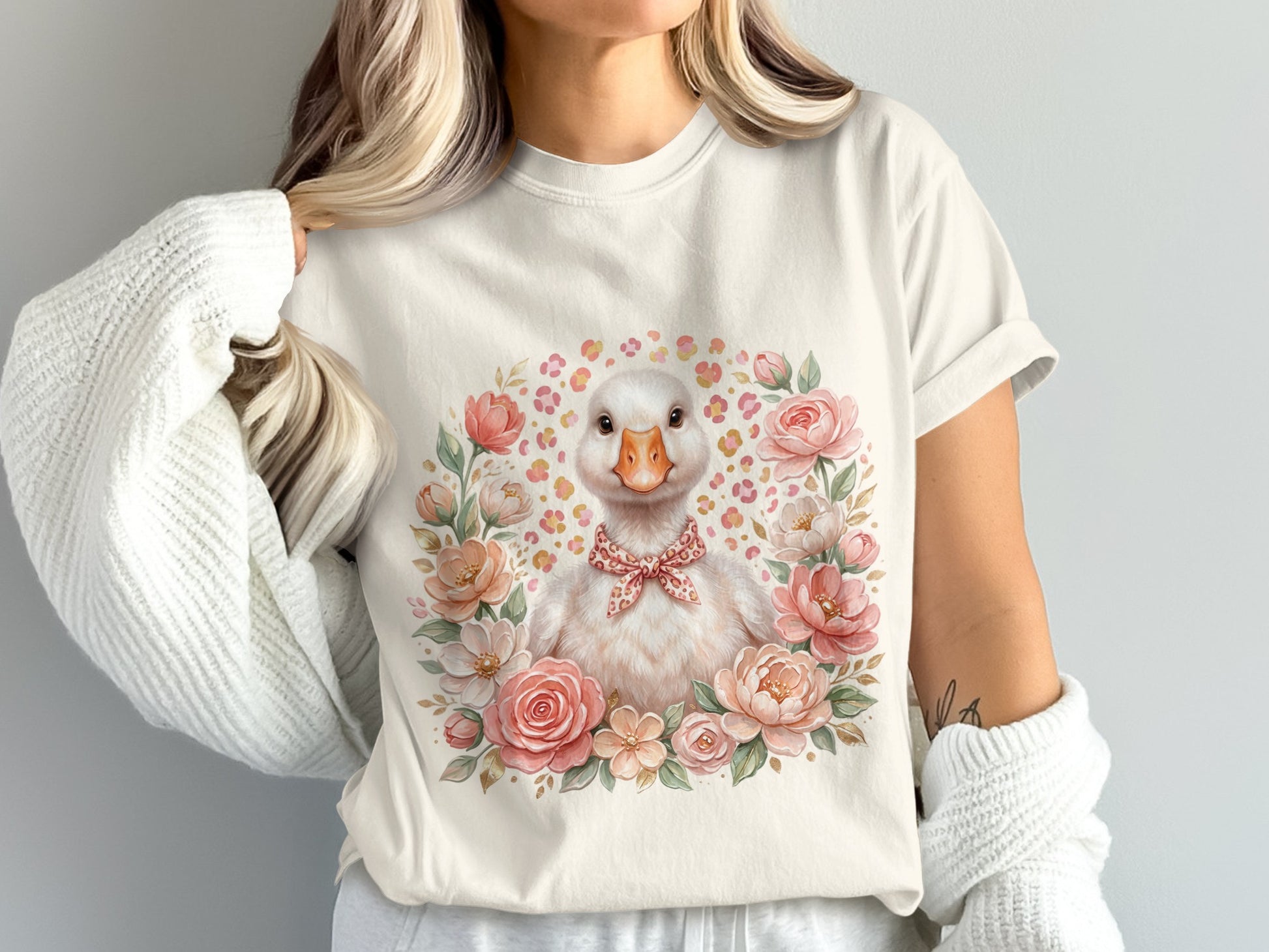 White t-shirt with watercolor duck wearing a bowtie in a floral wreath.