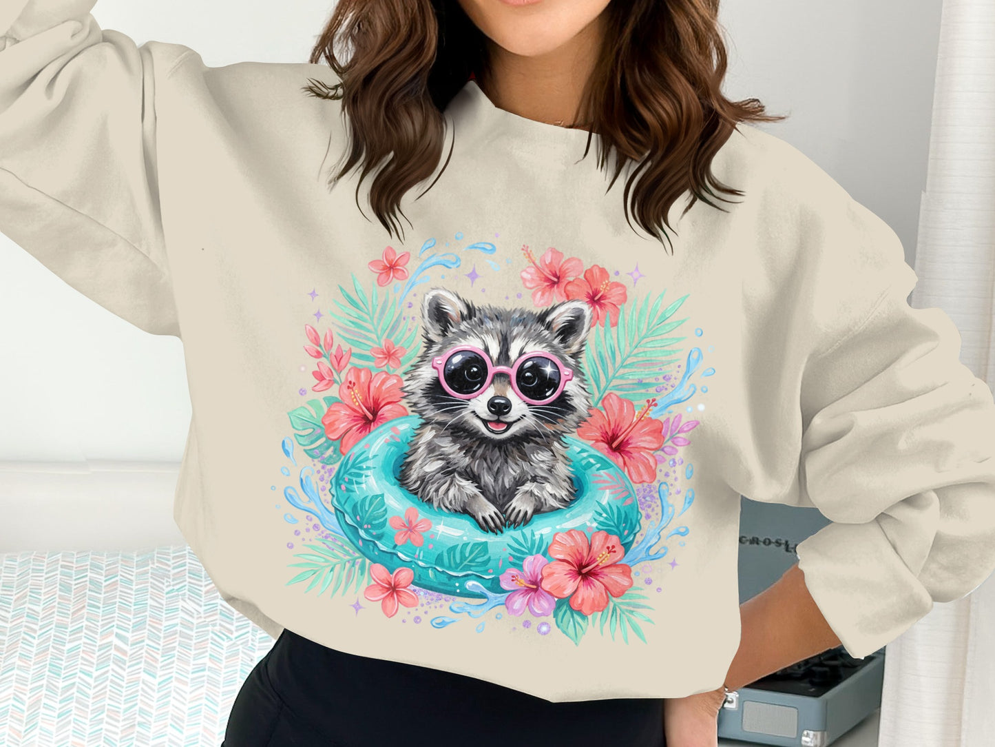 Crewneck sweatshirt with cartoon raccoon wearing sunglasses in a pool float.