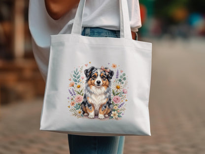 White tote bag featuring a cute Australian Shepherd dog surrounded by flowers.