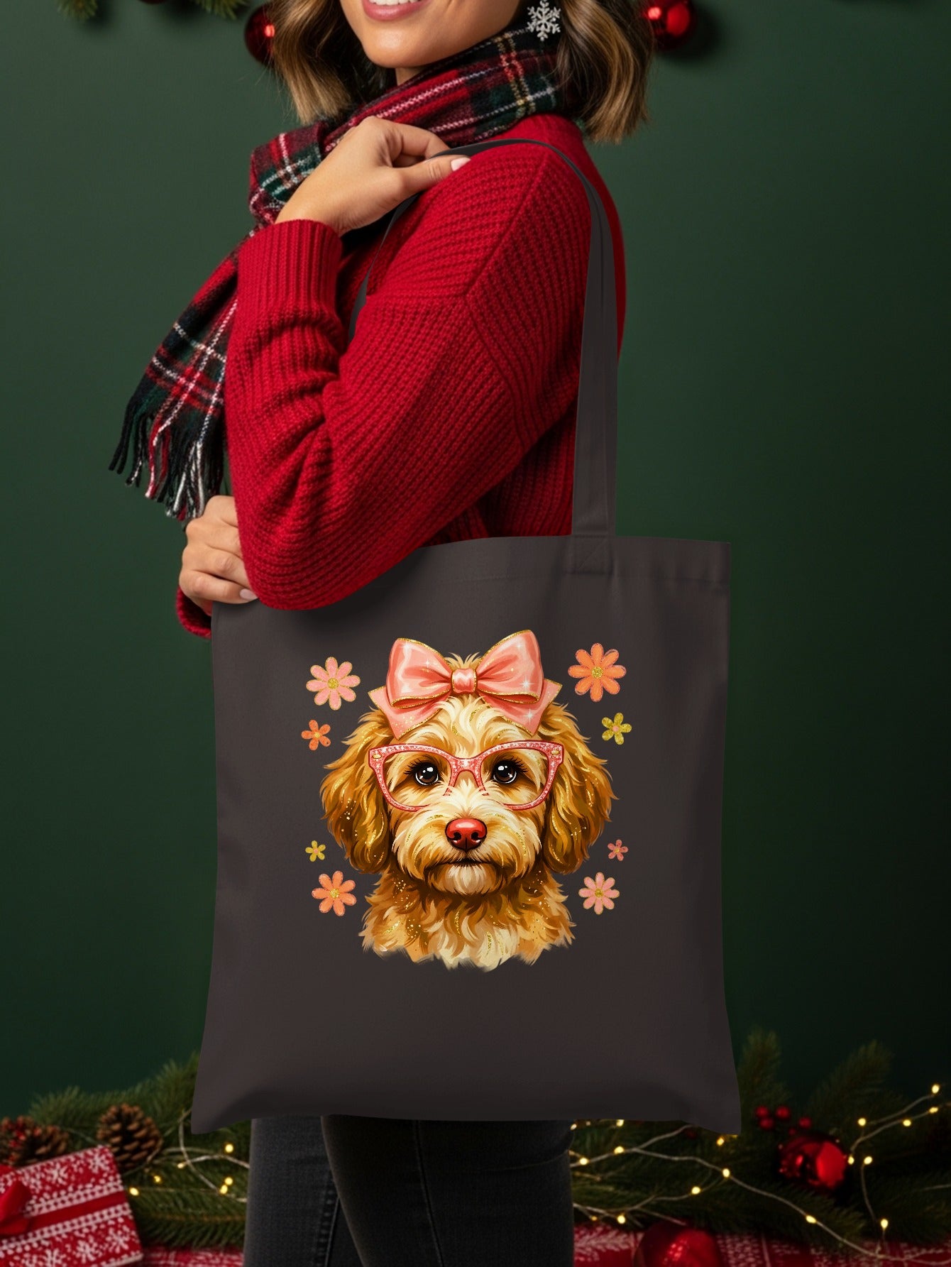Woman in red sweater holding dark tote bag with smiling dog wearing glasses and bow.