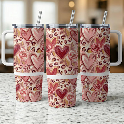 Three identical tumblers with pink and red hearts, roses, and leopard print.