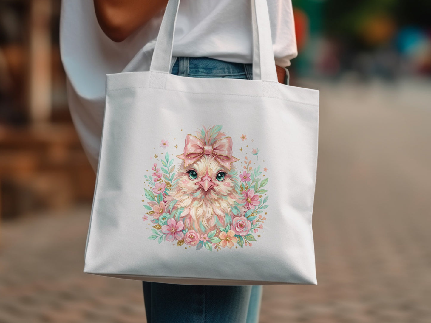 White tote bag with a pastel chick illustration, flowers, and a bow.