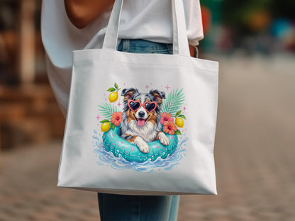Dog in inner tube with lemons and palm leaves on tote bag.