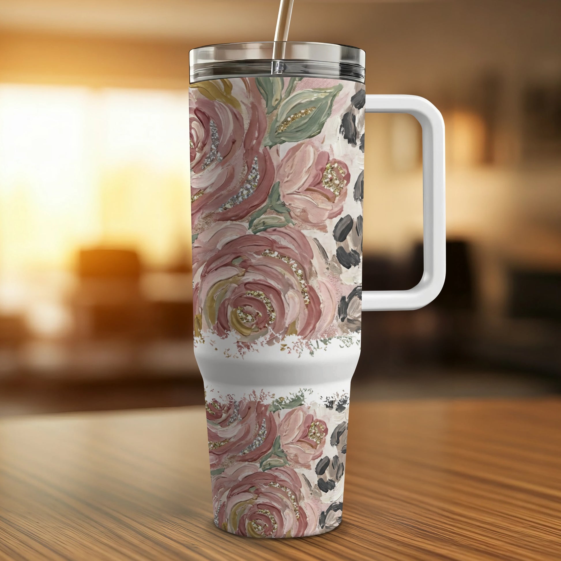 Floral and leopard print insulated tumbler with straw and handle.