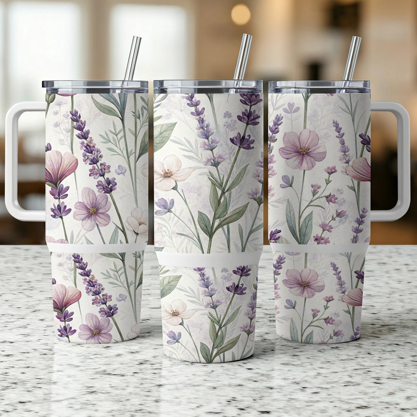 Three floral patterned tumblers with handles and straws.