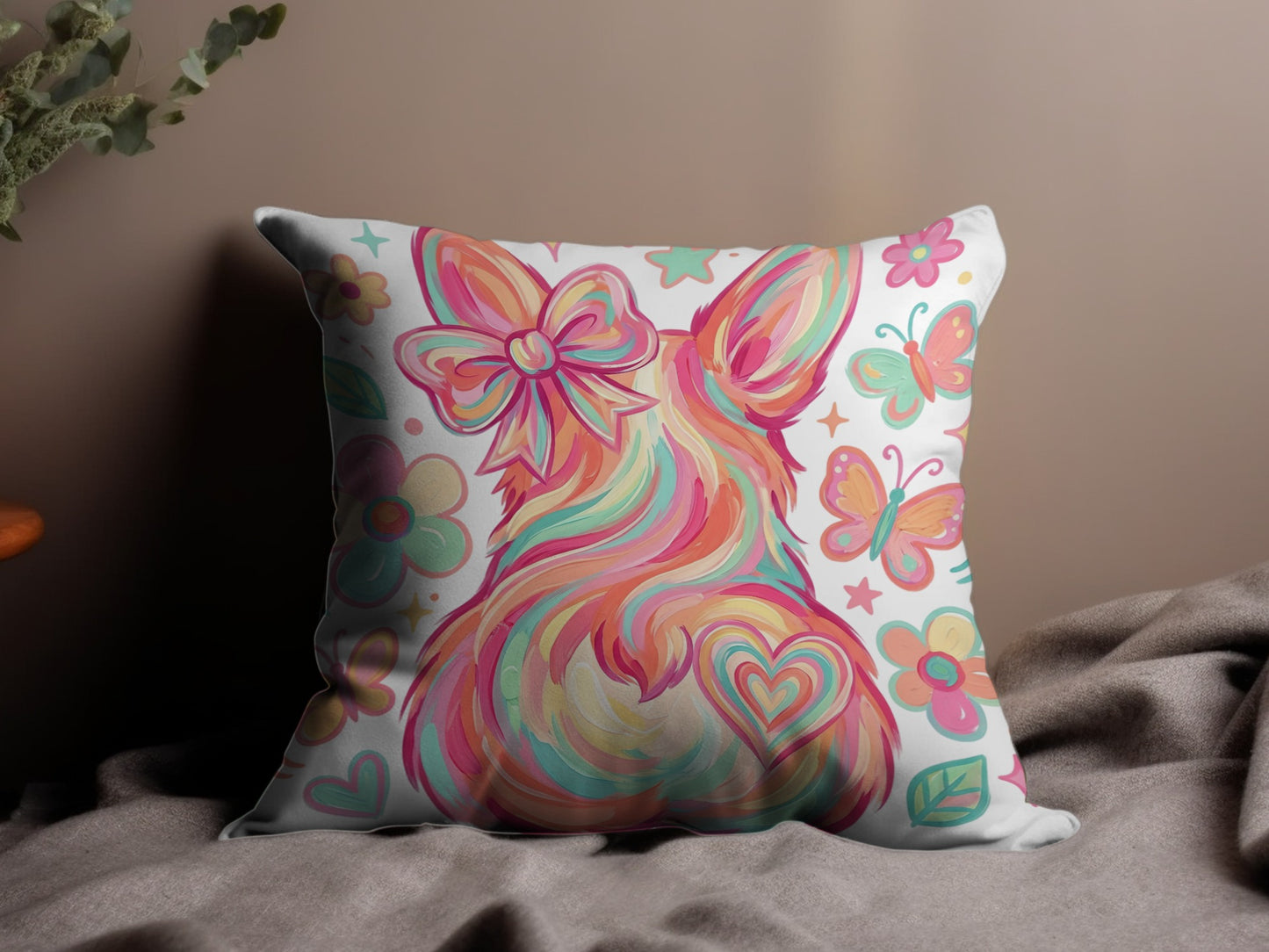 Fuzzy bunny pillow with colorful swirls, bow, hearts, and butterflies.