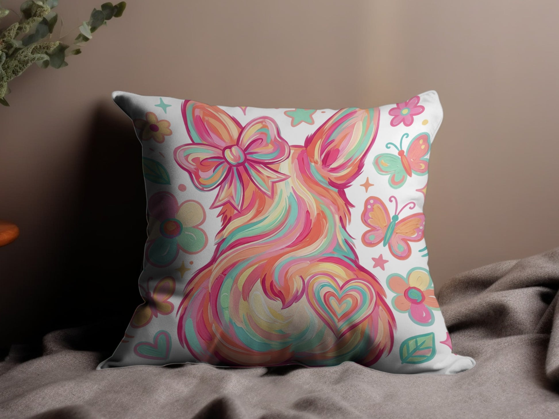 Fuzzy bunny pillow with colorful swirls, bow, hearts, and butterflies.