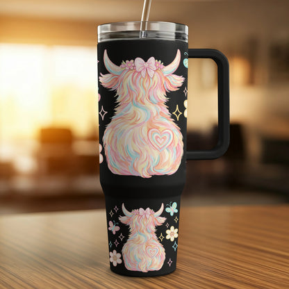 Black tumbler with fluffy pastel Highland cow, hearts, and butterflies design.