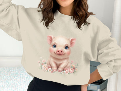 Crewneck sweatshirt with a cute pig illustration surrounded by flowers.