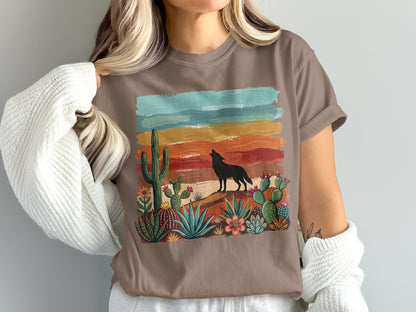 Brown t-shirt with wolf howling at sunset over desert landscape.