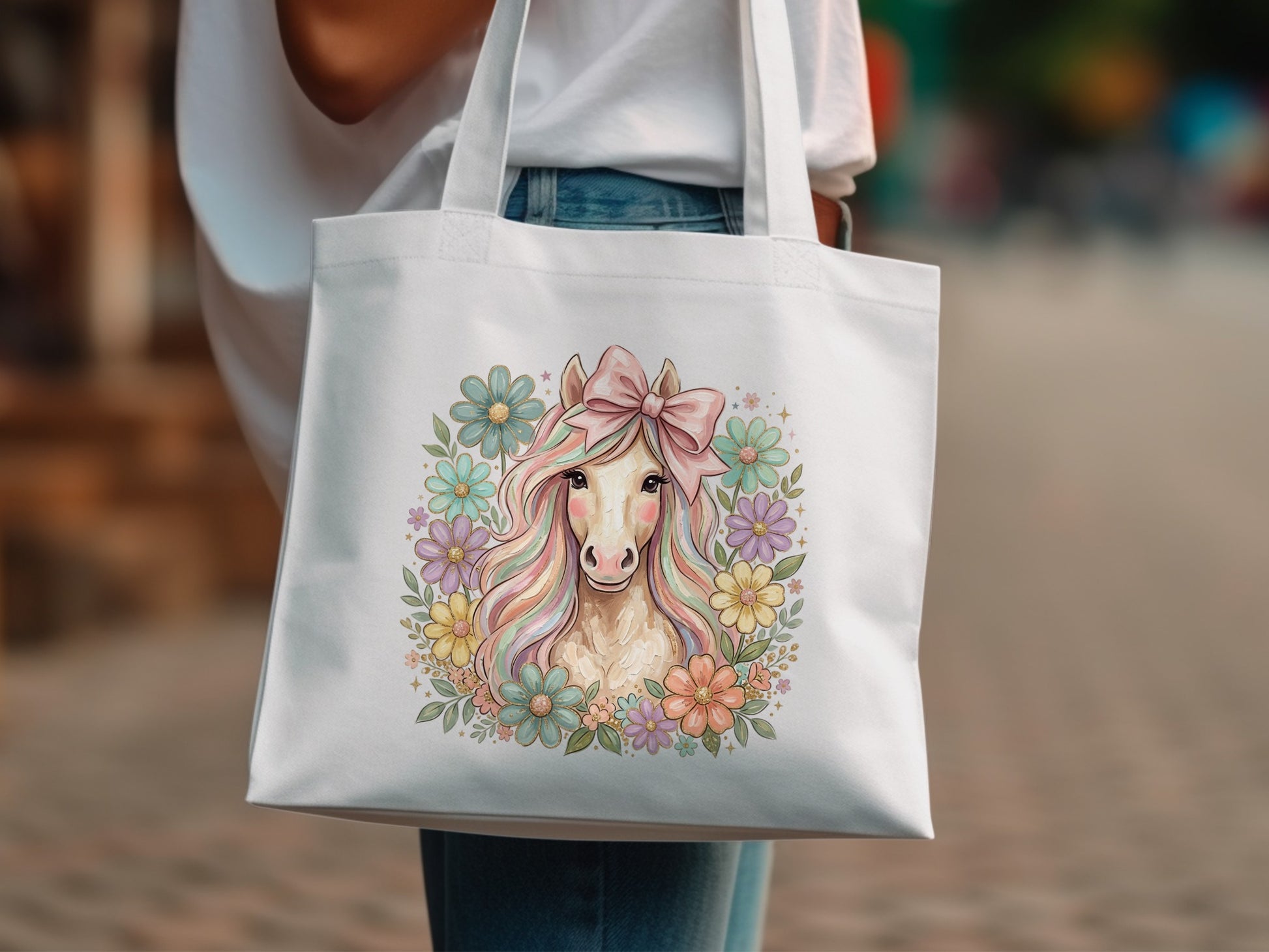 White tote bag with pastel unicorn and floral design.