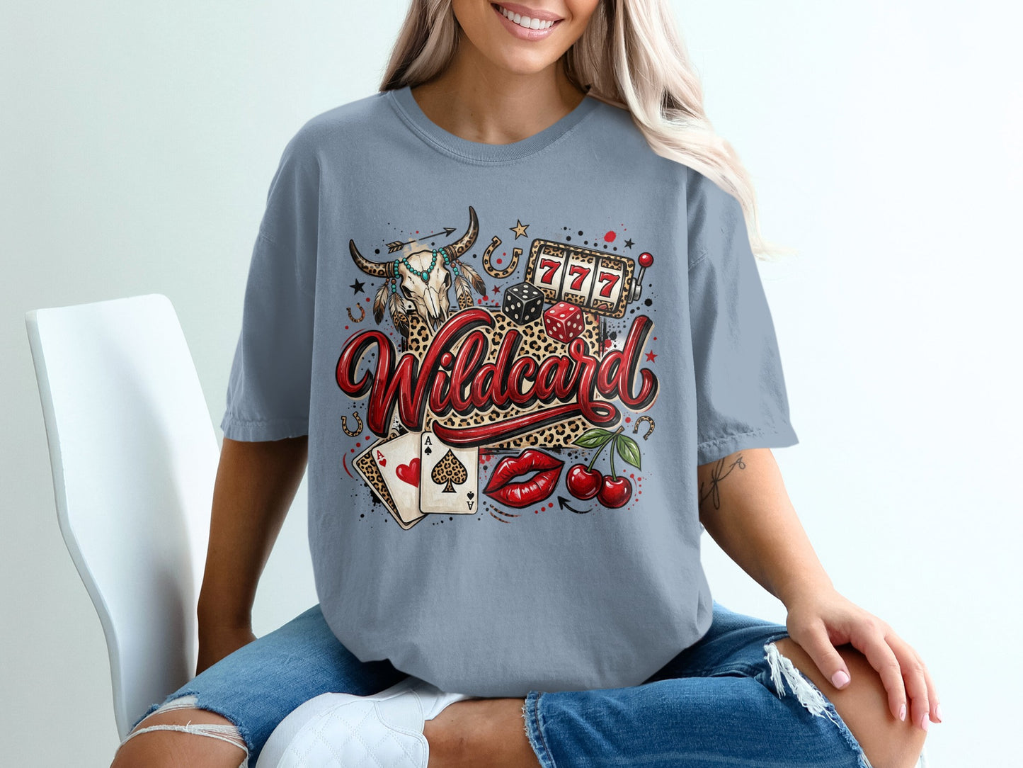 Woman wearing t-shirt with "Wildcard" text, bull skull, dice, cherries, and cards.