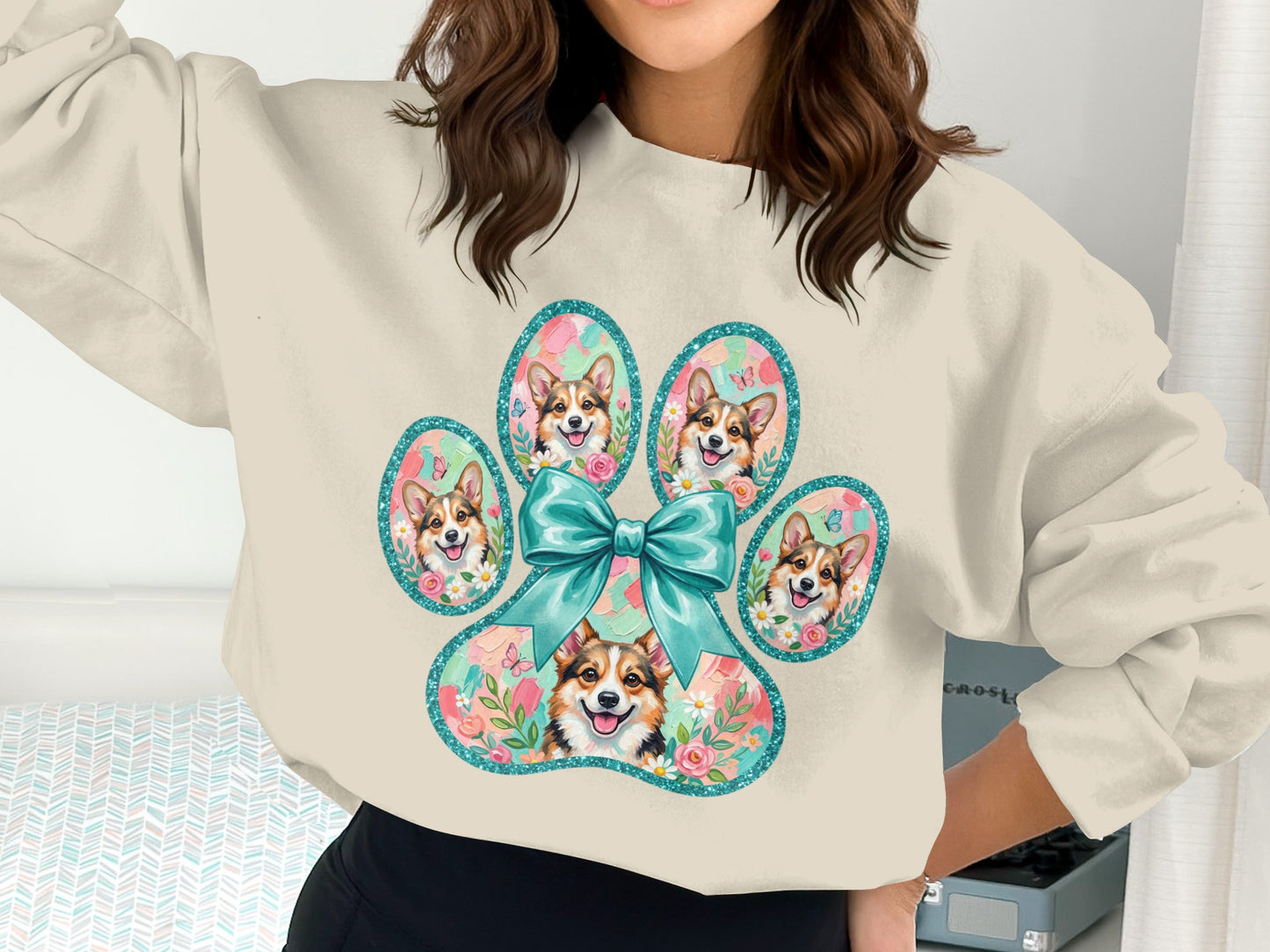 Cream sweatshirt with five Corgi faces within a paw print design.
