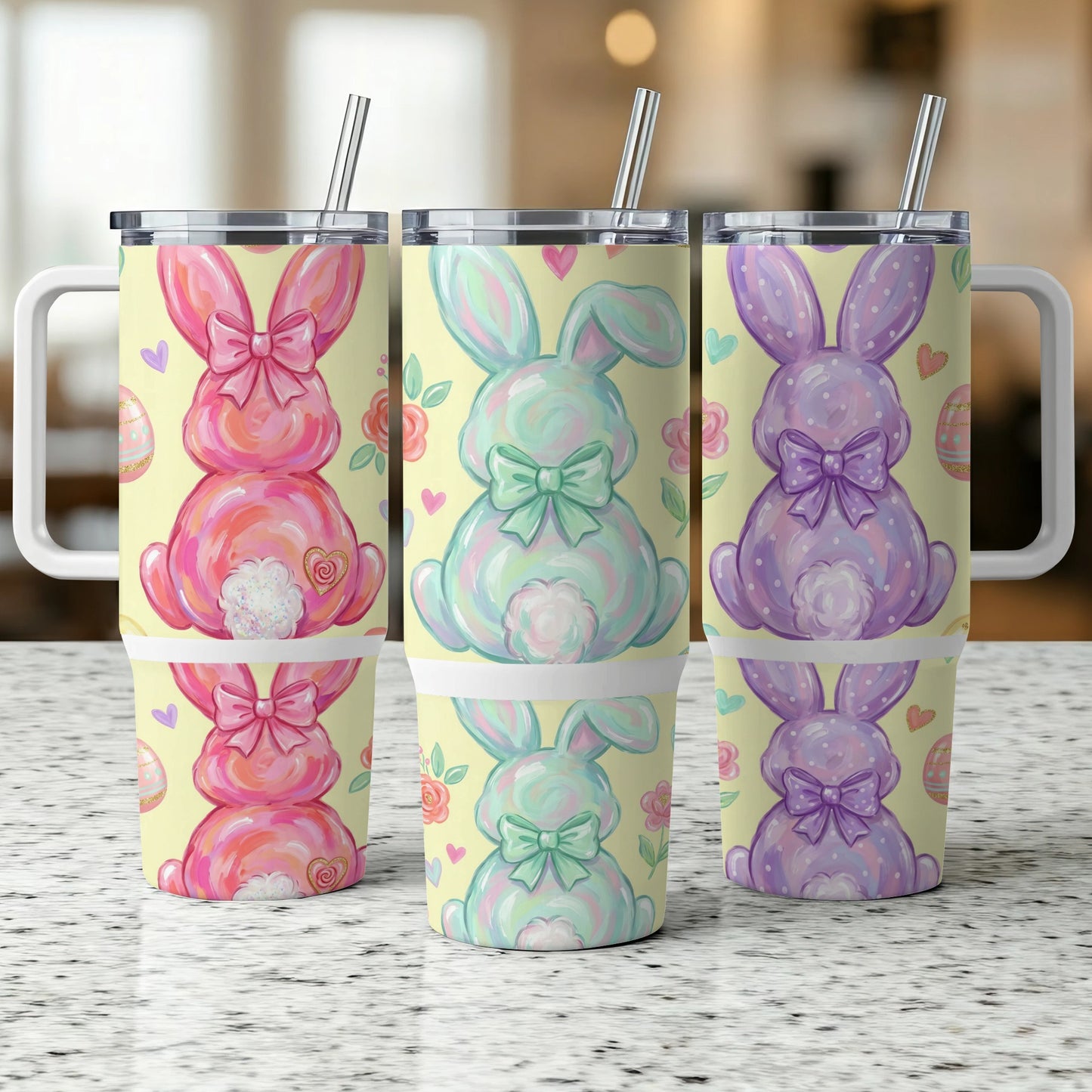 Three pastel Easter bunny tumblers with bows and egg designs.
