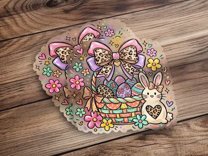 Easter basket with eggs, bunny, and bow stickers on a wooden surface.