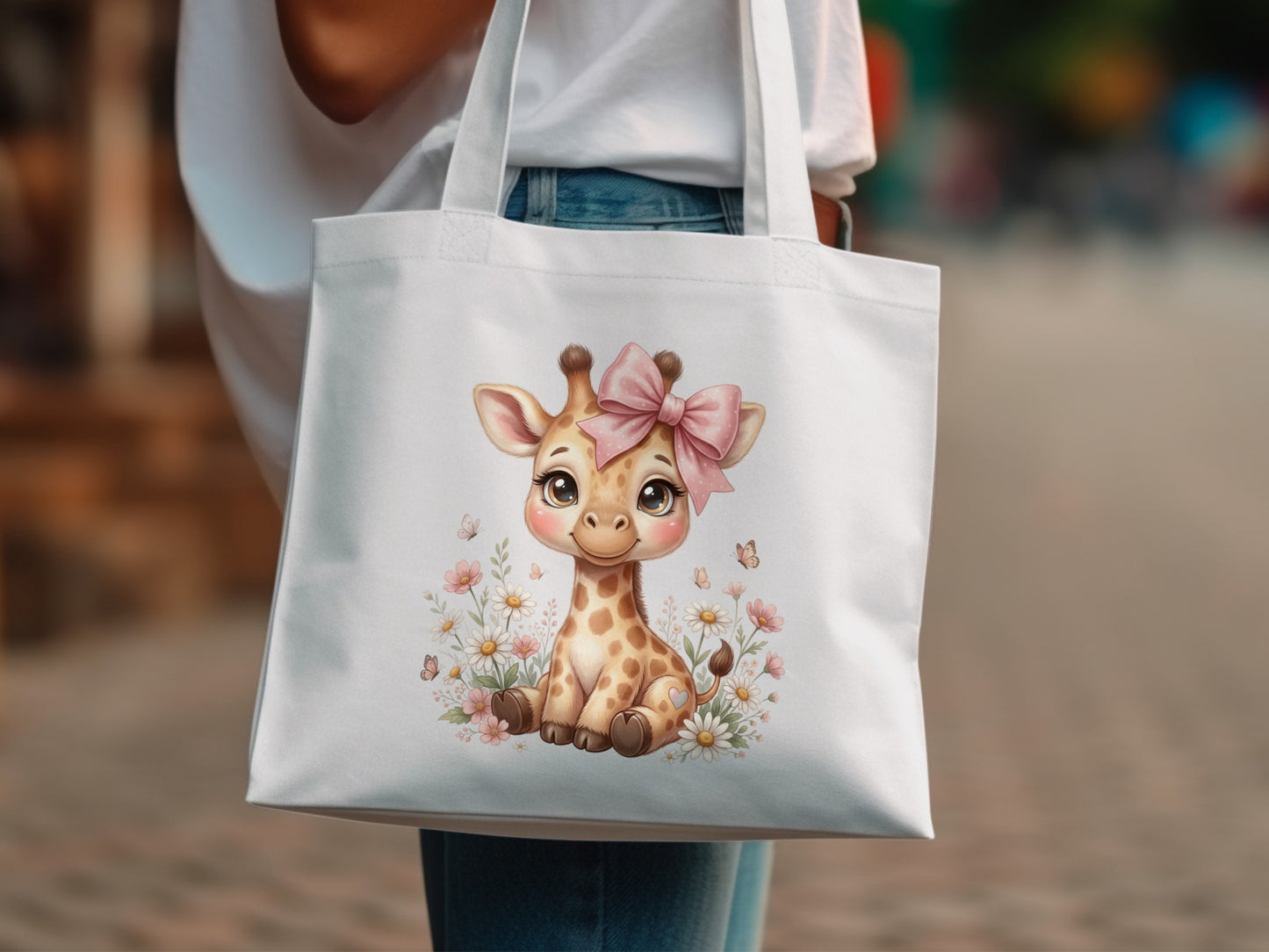 White tote bag with a cute cartoon giraffe and pink bow illustration.