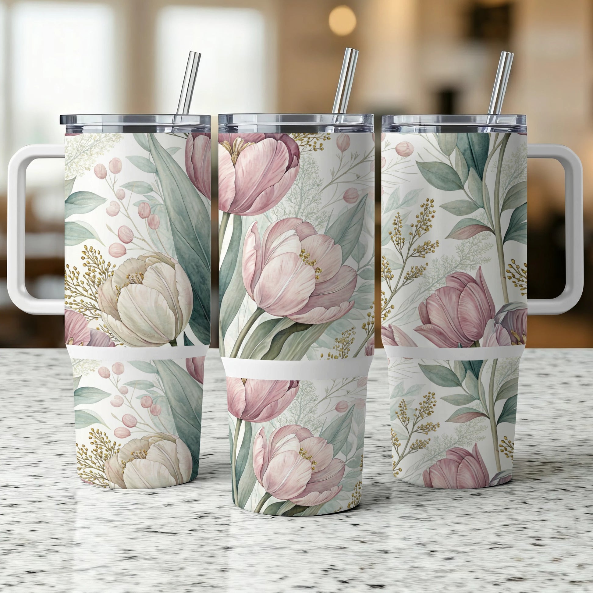 Three tumblers with pink floral patterns and handles, displayed on a speckled countertop.