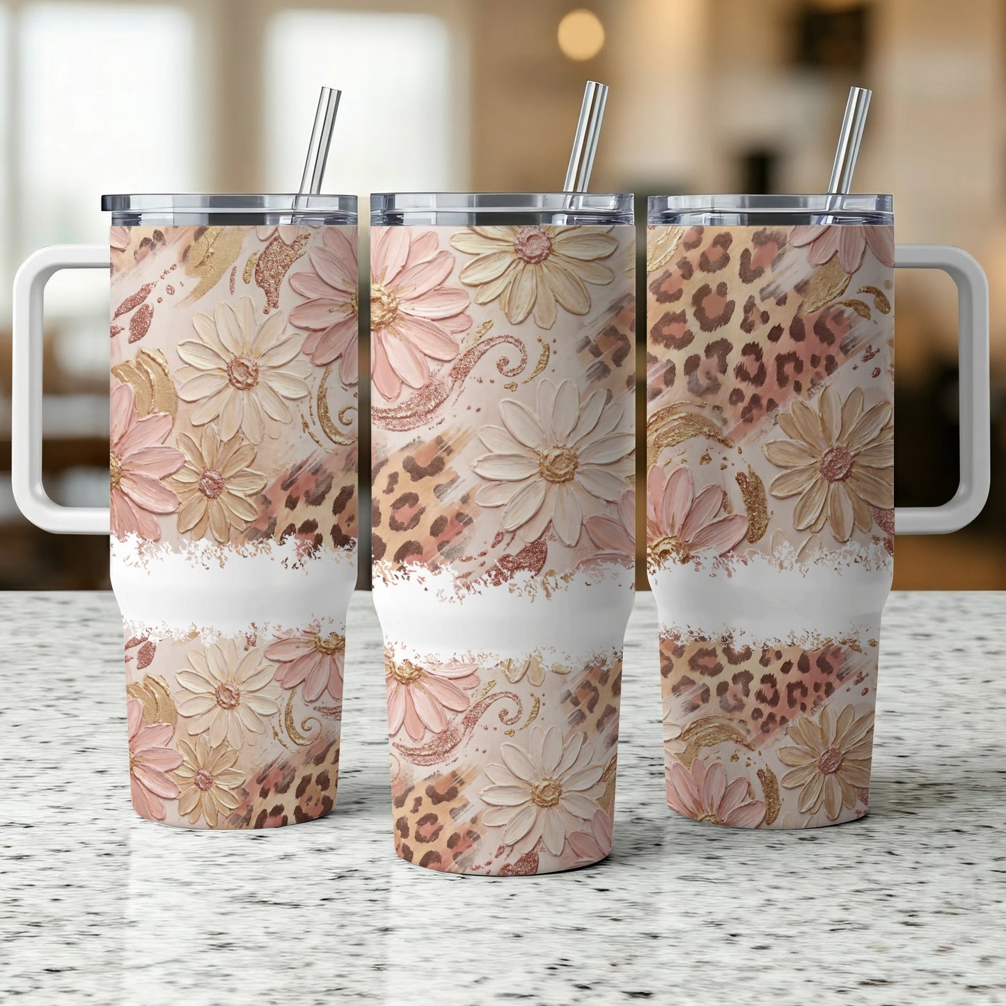 Three floral and leopard print tumblers with handles and straws.
