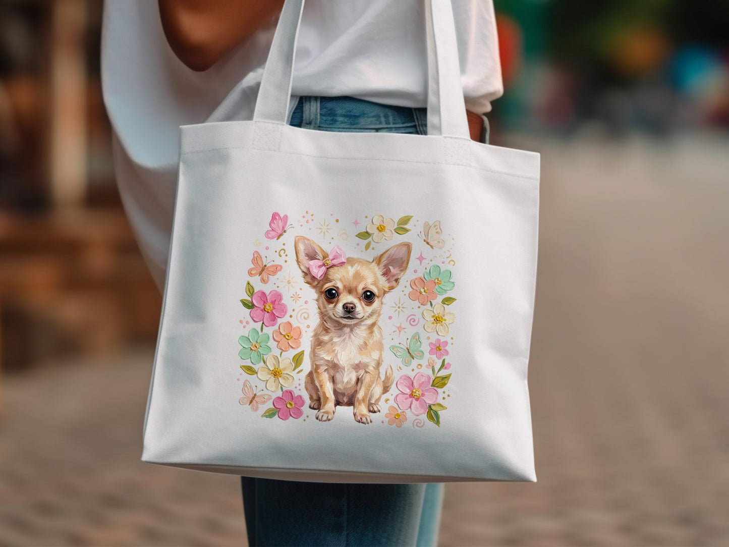 White tote bag with a chihuahua wearing a pink bow surrounded by flowers.