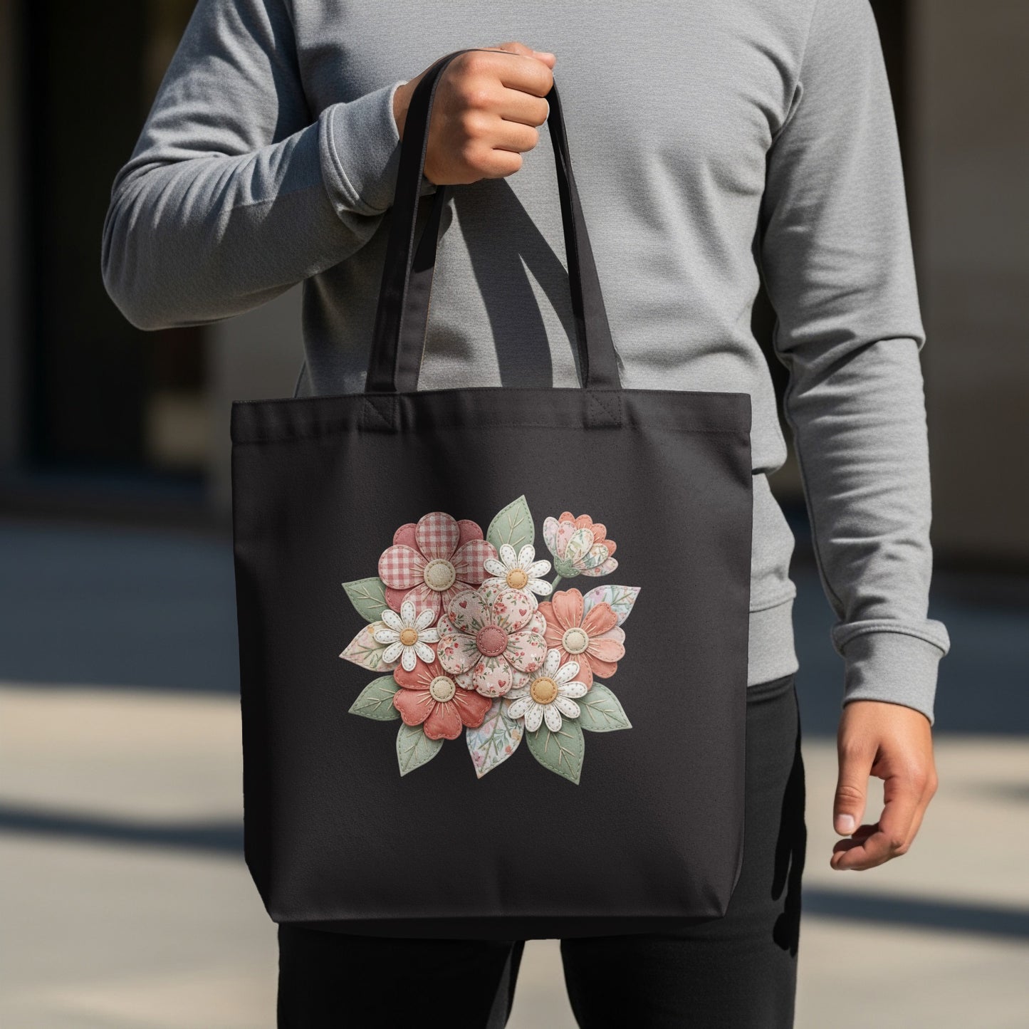 Black tote bag with a floral bouquet design.